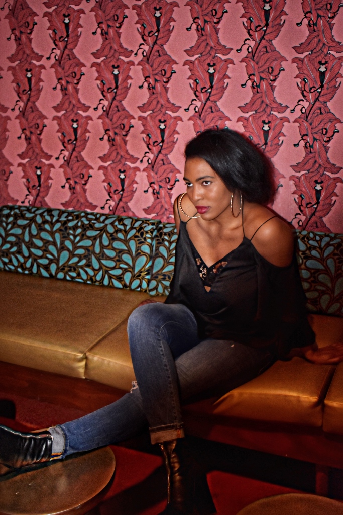 Wearing ripped Urban Outfitters jeans, an off-shoulder Topshop camisole and black Zara booties at Punch Bowl Social Chicago.